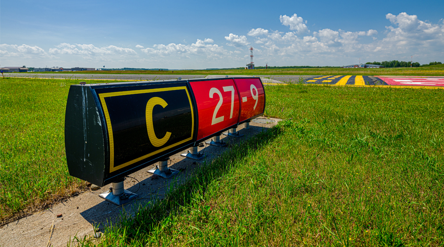 Runway designator sign in grass field